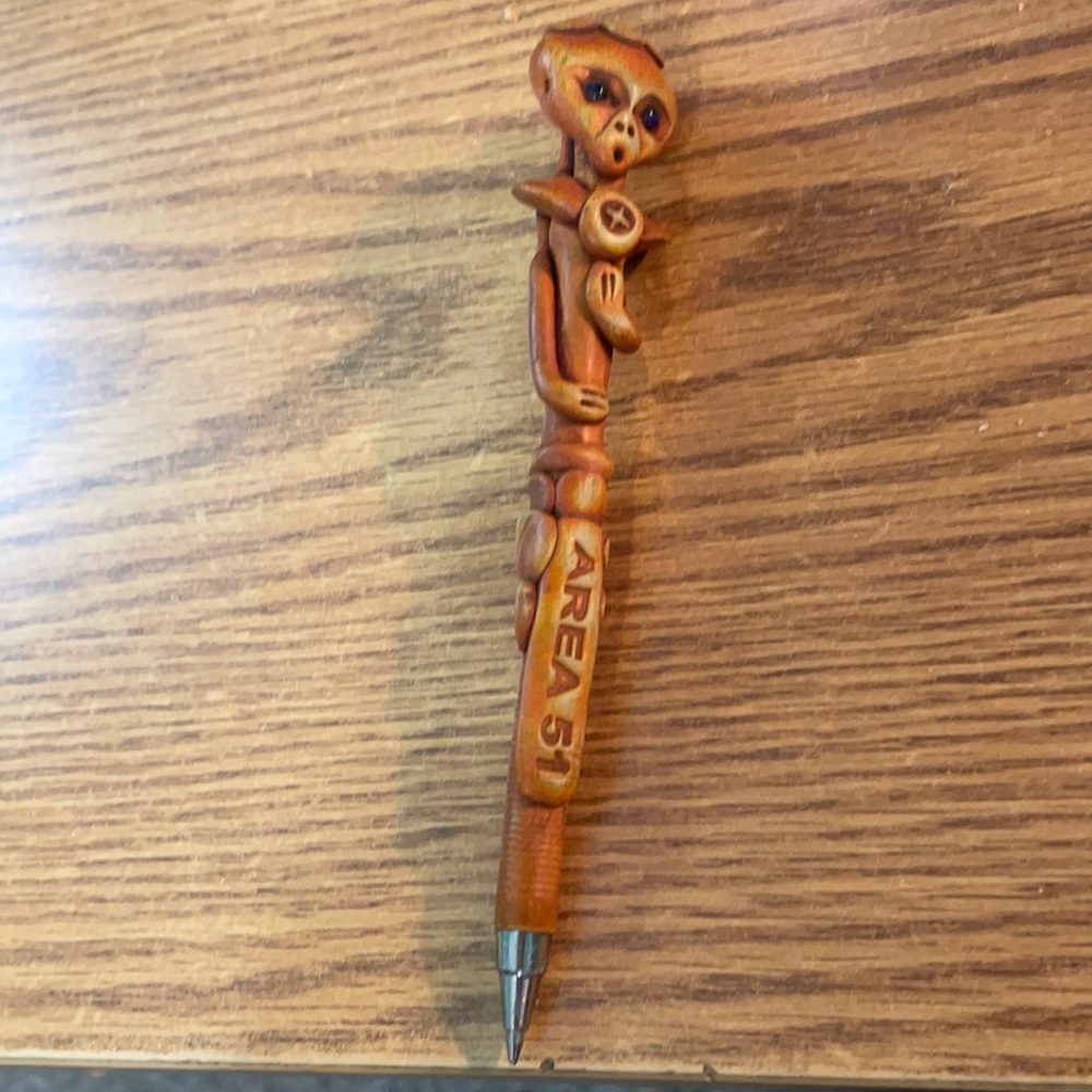 An Area 51 Pen man in hard plastic with a never been used ink source inside.